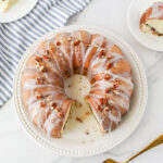 Sock it to me bundt cake with glaze on a white plate.