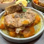 Crock Pot pork chops on a plate with sweet potatoes