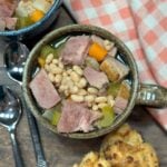 Crock pot ham and beans with vegetables in a bowl.