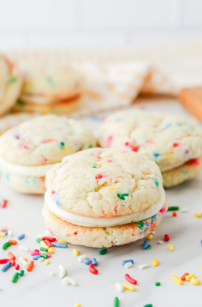 Funfetti cookies on a counter with sprinkles.