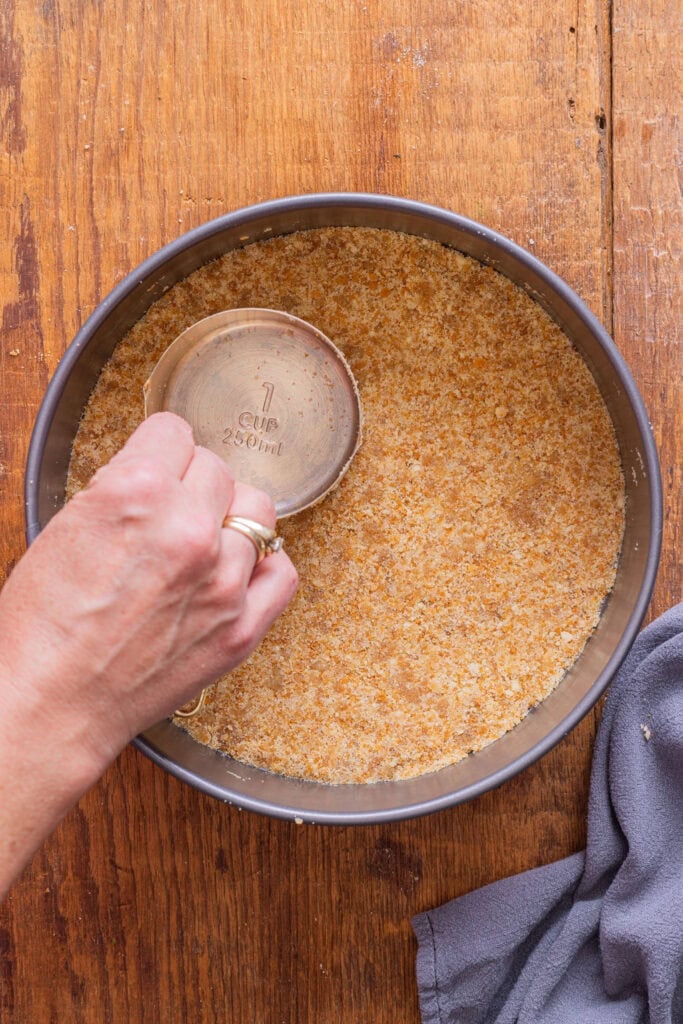 Crushed Nilla Wafers in a springform pan.