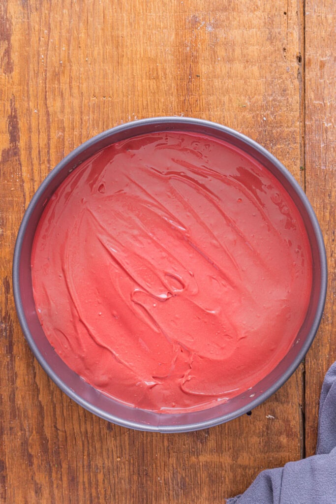 REd velvet cheesecake batter in a springform pan.