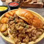 Homemade sloppy joe recipe on a plate with tater tots.