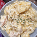 Slow cooker chicken and dumplings with biscuits in a bowl.