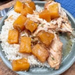 Slow cooker pineapple chicken on a plate with white rice.