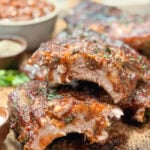 Sliced sticky pork ribs on a cutting board.