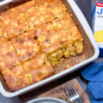 Baked loaded Jiffy cornbread in a square baking dish.