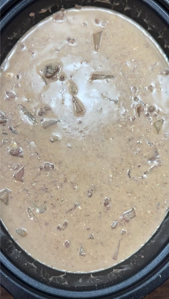 Cooked cheeseburger soup in a slow cooker.