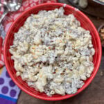 Creamy pasta with beef and Italian sausage in a red bowl.