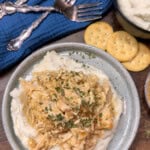 Crock Pot Ritz Cracker chicken casserole on a plate on top of mashed potatoes.