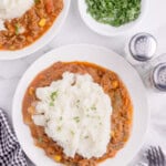 Slow cooker shepherd's pie on a plate with mashed potatoes on top.