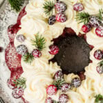 Red velvet bundt cake with cream cheese frosting on top.