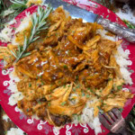 Crock Pot honey soy dinner shredded on a plate on top of white rice.