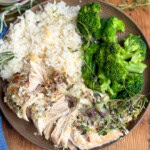 Slow cooker cheesy chicken on a plate with rice and broccoli