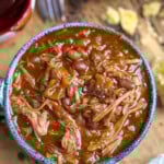 Slow cooker pork and beans in a blue bowl.