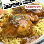 A plate of rice topped with Crock Pot Southern Smothered Chicken that falls apart in savory brown gravy sits next to bread. Text reads: Crock Pot Smothered Chicken, 5-Minute Prep! Get The Recipe! backtomysouthernroots.com.