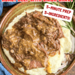 A plate of mashed potatoes topped with savory shredded roast beef and onion gravy, featuring our 5-Ingredient Crock Pot Roast Beef with Onion Gravy—just 5 minutes of prep for a hearty, comforting meal.